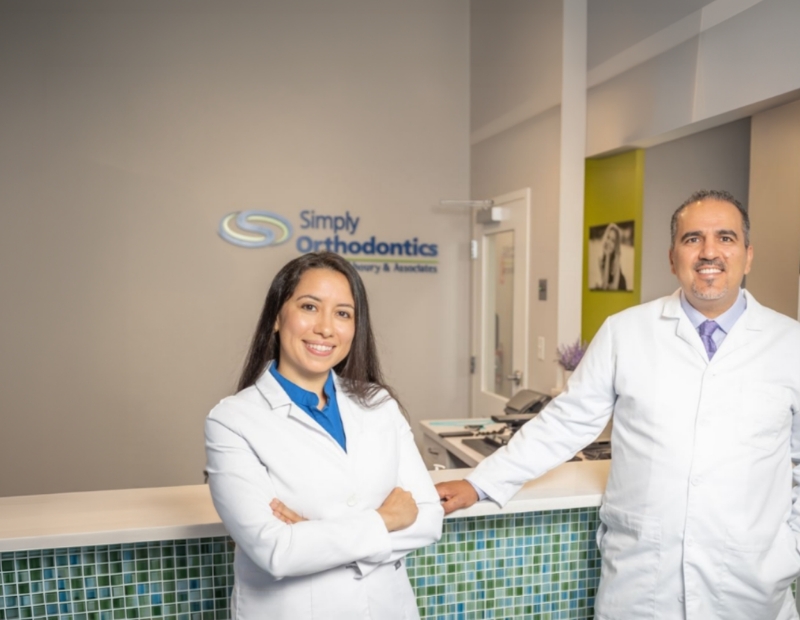 Dr. Sam Alkhoury and woman doctor standing in the front office of Simply Orthodontics.