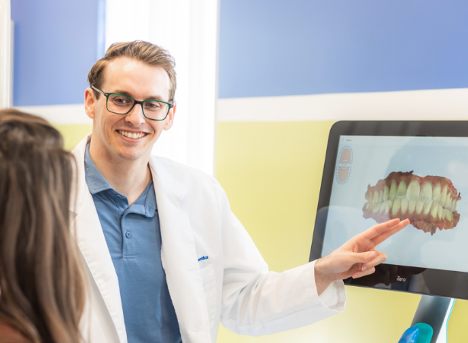 Dentist showing teeth diagram to patient.