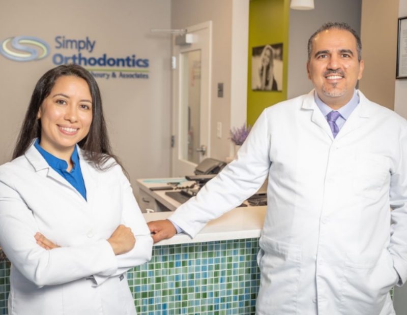 Dr. Sam Alkhoury and woman doctor standing in the front office of Simply Orthodontics.