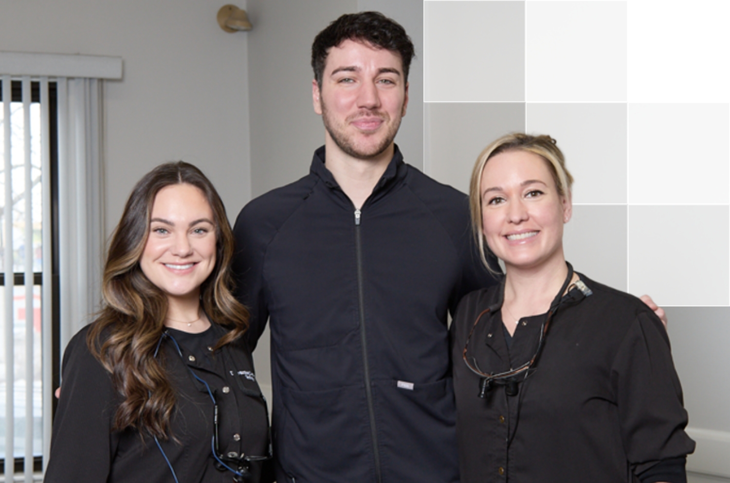 Man and women smiling in dentistry setting.